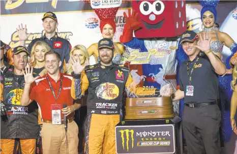  ?? CHASE STEVENS/AP ?? Martin Truex Jr. is presented with the trophy after winning Sunday at the Las Vegas Motor Speedway. It was his fifth victory of the season.