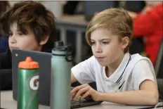  ?? TIMOTHY D. EASLEY — THE ASSOCIATED PRESS ?? Caleb Roberts, right, and his classmates attempt to “Find the Bot” in Donnie Piercey’s fifth-grade class at Stonewall Elementary in Lexington, Ky., Monday, Feb. 6, 2023.