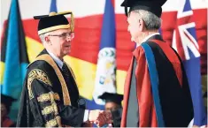  ?? GLADSTONE TAYLOR/ PHOTOGRAPH­ER ?? UWI Chancellor Robert Bermudez (left) greets Antony Keith Edmund Hart after Hart was conferred with the Honorary degree of Doctor of Laws.