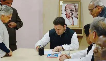  ??  ?? Congress vice-president Rahul Gandhi, surrounded by party leaders, files his nomination papers for party president’s post on Monday. —