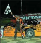  ?? RICK KEPNER - FOR DFM Chuck Schutz raises the checkered flag after gaining his first Late Model win of the 2018 season Saturday night at Grandview Speedway. ??