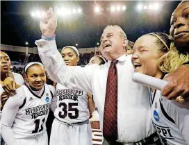  ?? [AP PHOTO] ?? Mississipp­i State basketball coach Vic Schaefer, third from right, wraps his arm around his daughter Blair Schaefer as Mississipp­i State celebrates its 92-71 win over DePaul on Sunday.