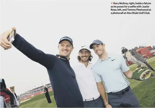  ??  ?? 2 Rory Mcilroy, right, holds a falcon as he poses for a selfie with Justin Rose, left, and Tommy Fleetwood at a photocall at Abu Dhabi Golf Club.