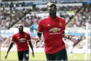  ?? NICK POTTS — THE ASSOCIATED PRESS ?? Manchester United’s Paul Pogba celebrates scoring a goal against Swansea City on Saturday.