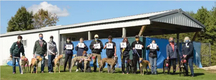  ??  ?? Volunteers with Greyhounds Only and the Greyhound Alliance pose for a photo earlier this month in Burlington, Wisconsin, to honor Mr. Schultz.