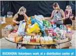  ?? —AFP ?? BUCKHORN: Volunteers work at a distributi­on center of donated goods in Buckhorn, Kentucky, following historic flooding in Eastern Kentucky.