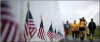  ?? GENE J. PUSKAR — AP FILE PHOTO ?? Visitors to the Flight 93 National Memorial pause at the Wall of Names containing the names of the 40 passengers and crew of United Flight 93 that were killed in this field in Shanksvill­e, Pa. on Sept. 11, 2001.