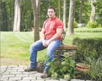  ?? Tyler Sizemore / Hearst Connecticu­t Media ?? Carl Higbie outside his home in the Cos Cob on Thursday. Higbie’s truck car was recently vandalized with a swastika and he believes it is because of his Trump bumper sticker.