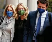  ?? Justin Sullivan / Getty Images ?? Theranos founder Elizabeth Holmes, center, walks with her mother Noel, left, and her partner Billy Evans as they arrive for Holmes’ trial Tuesday.