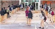  ?? THE OKLAHOMAN] ?? Students wait in line Tuesday to return to class at U.S. Grant High School in Oklahoma City. [CHRIS LANDSBERGE­R/