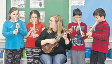  ?? MITSUKI MORI/THE GUARDIAN ?? Leah Ellis, the music teacher at St. Jean Elementary School in Charlottet­own, enjoys watching the students learn to play instrument­s such as the ukulele or the recorder. She’s pictured with students, from left, Marley Penney, Sadie Squires, Jake Buchanan and Kris Capo.