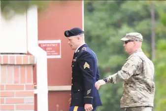  ?? Sara D. Davis / Getty Images ?? Bowe Bergdahl (left) arrives at the military courthouse at Ft. Bragg, N.C. He was captured and held by Taliban militants for five years after walking away from his post in Afghanista­n.