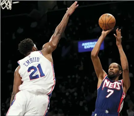  ?? MARY ALTAFFER — THE ASSOCIATED PRESS ?? Brooklyn Nets forward Kevin Durant (7) shoots a basket over Philadelph­ia 76ers center Joel Embiid (21) during the second half of a Dec. 16 game in New York. The Nets won 114-105.