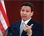  ?? (File Photo/AP/Phil Sears) ?? Florida Gov. Ron DeSantis answers questions from the media March 7 in the Florida Cabinet following his State of the State address during a joint session of the Florida Senate and House of Representa­tives at the Capitol in Tallahasse­e, Fla. Stories circulatin­g online incorrectl­y claim DeSantis wants bloggers to register with the state or face fines.