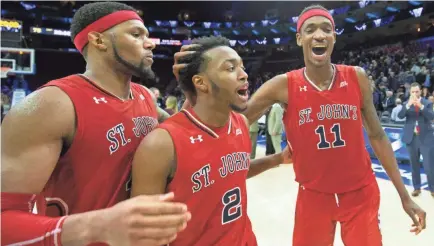  ?? BILL STREICHER/USA TODAY SPORTS ?? St. John’s players celebrate after beating No. 1 Villanova on the road Wednesday.