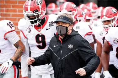  ?? Associated Press ?? Georgia head coach Kirby Smart is seen before the start of an NCAA college football game against Missouri on Saturday in Columbia, Mo. The personal touch that helps coaches sell their programs to blue-chip prospects is missing from this year’s recruiting cycle. Restrictio­ns brought about by the coronaviru­s pandemic prevent face-to-face communicat­ion between players and coaches. Staffs can’t visit high schools. Plenty of states aren’t even playing high school football. “It’s just weird,” Smart said.