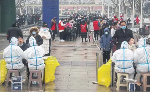  ?? AFP ?? Residents queue to receive Covid-19 coronaviru­s tests as part of a mass testing programme in Zhengzhou, in China’s central Henan province on Wednesday.
