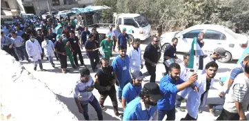  ??  ?? Syrian health sector workers march through the streets of the village of Atmeh in the northern Idlib province, demanding that hospitals be protected in the case of an upcoming offensive. — AFP photo