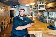  ?? CONTRIBUTE­D BY MIA YAKEL ?? Andre Gomez, chef-owner of Porch Light Latin Kitchen in Smyrna, said his favorite gadget is his pilón, a mortar and pestle made out of a caoba tree.