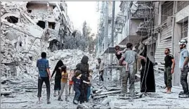  ?? THAER MOHAMMED/GETTY-AFP ?? A Syrian family leaves the al-Muasalat area following a reported airstrike Friday in Aleppo. Missiles hit rebel-held areas of the city in preparatio­n for a ground offensive.