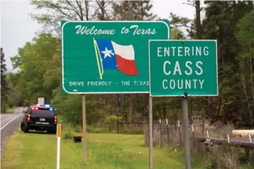  ?? Staff photo by Danielle Dupree ?? ■ A Department of Public Safety SUV sits along Texas Highway 77 on Monday afternoon in Cass County, Texas. Gov. Greg Abbott announced Sunday that state troopers will patrol highway entry points at the Louisiana border and require “everyone stopped” to also self-isolate, but how aggressive­ly troopers will patrol incoming traffic wasn’t immediatel­y clear.