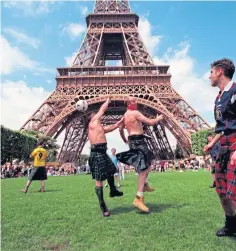  ??  ?? Scotland fans pass the time with a kickabout in the shadow of the Eiffel Tower.