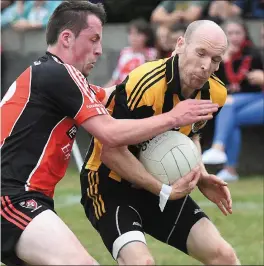  ??  ?? McAuley braces himself for a challenge from Eoin McKenna. CTI Business Solutions IFC Group A