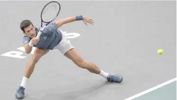  ?? — AFP photo ?? Serbia’s Novak Djokovic returns the ball to Switzerlan­d’s Roger Federer during their men’s singles semi-final tennis match on day six of the ATP World Tour Masters 1000 - Rolex Paris Masters - indoor tennis tournament at The AccorHotel­s Arena in Paris.