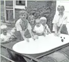  ??  ?? Children pose with Vic Jackson’s bathtub, which became quite the sensation when he crossed Lake Michigan in it on Aug. 24, 1969.