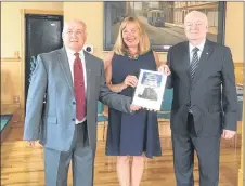  ?? ADAM MACINNIS/THE NEWS ?? Clyde Macdonald and Philip MacKenzie present New Glasgow Mayor Nancy Dicks with a copy of a historical booklet they’ve created called “Some Dated Buildings and Structures in New Glasgow.”