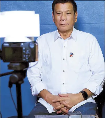  ??  ?? President Duterte has his passport photo taken at a mobile registrati­on booth set up by the Department of Foreign Affairs at Malacañang yesterday. Duterte applied for a new passport, now as President, ahead of his official trips to Brunei and Indonesia...