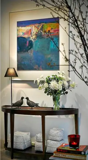  ??  ?? (Left) A colourful abstract painting by Tajuddin Ismail hangs over the mahogany glass-top console table by Abitex.