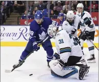  ?? HANS DERYK – THE CANADIAN PRESS VIA AP ?? The Maple Leafs’ William Nylander, left, goes for a rebound in front of Sharks goaltender Martin Jones during the second period.