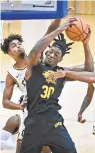  ?? KENNETH K. LAM/ BALTIMORE SUN ?? UMBC’s Daniel Akin is fouled by Coppin State’s Chereef Knox (2) on Sunday.