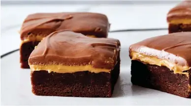  ?? YOSSY AREFI/THE NEW YORK TIMES ?? Joanna Gaines’ peanut butter brownies are a hybrid of cookie and candy bar.