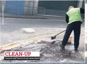  ??  ?? CLEAN-UP Council staff had to brush away blood