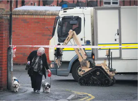  ?? KEVIN SCOTT ?? Dark days:
Police at a security alert at Devonshire Place in west Belfast