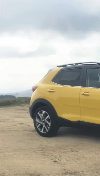  ?? ?? YELLOW SLICK ROAD: Main picture and above left, the Kia Stonic GT-Line S 48v features plastic cladding along the skirts, front and rear skid plates and hefty roof rails; below right, the dashboard screen has primary manual control switches below.