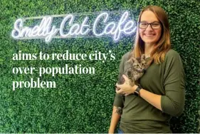  ?? ?? Far left: Owner Brooklynn Bishop holds a kitten in front of the Smelly Cat Cafe marquee on May 23.