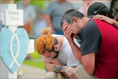  ?? DARIO LOPEZ-MILLS/AP PHOTO ?? Vincent Salazar, right, father of Layla Salazar, weeps Friday while kneeling in front of a cross with his daughter’s name at a memorial site for the victims killed in this week’s elementary school shooting in Uvalde, Texas.