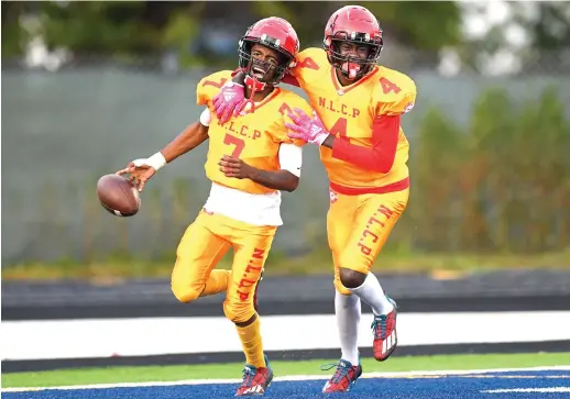  ?? KIRSTEN STICKNEY/SUN-TIMES ?? Anton Mosley (7) and Damonta Jackson enjoy the moment after Mosley hauled in a 70-yard touchdown pass in the third quarter of North Lawndale’s rout of Hansberry at Rockne Stadium.