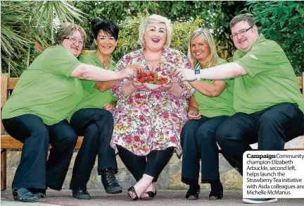  ??  ?? Campaign Community champion Elizabeth Arbuckle, second left, helps launch the Strawberry Tea initiative with Asda colleagues and Michelle McManus