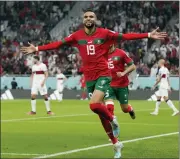  ?? MARTIN MEISSNER — THE ASSOCIATED PRESS ?? Morocco’s Youssef En-Nesyri celebrates after scoring his side’s first goal during the World Cup quarterfin­al match on Saturday between Morocco and Portugal, at Al Thumama Stadium in Doha, Qatar.
