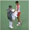  ?? (AFP) ?? Serbia’s Novak Djokovic using a towel during his men’s singles first round match at the Shanghai Masters on Tuesday.