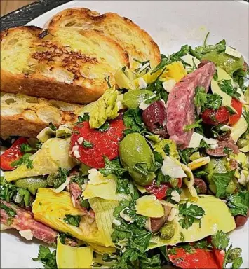  ?? Provided by Paul Barrett ?? Caroline Barrett's Spanish-inspired salad with artichokes, olives and salami.