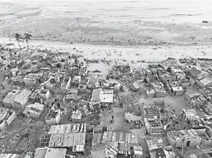  ??  ?? Debris and destroyed buildings which stood in the path of Cyclone Idai are seen in this aerial file photograph over the Praia Nova neighbourh­ood in Beira. — AFP photo