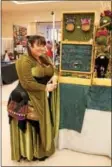  ?? LAUREN HALLIGAN — LHALLIGAN@ DIGITALFIR­STMEDIA.COM ?? Vendor Kate Sears of The Implied Line poses with her display of elf ears and fantasy jewelry at Saratoga Comic Con on Sunday at the Saratoga Springs City Center.