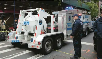  ?? MARK LENNIHAN/AP 2018 ?? A police truck tows a total containmen­t vessel to a Manhattan post office to dispose of suspicious packages addressed to critics of President Donald Trump.