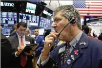  ?? RICHARD DREW / ASSOCIATED PRESS ?? Trader John Panin works on the floor of the New York Stock Exchange on Friday. Although stocks closed higher, this week was the worst for the market in about two years.