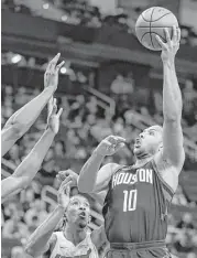  ?? Brett Coomer / Houston Chronicle ?? Rockets guard Eric Gordon, right, puts up a shot over Heat forward Josh Richardson. Gordon scored 16 points in 29 minutes off the bench.